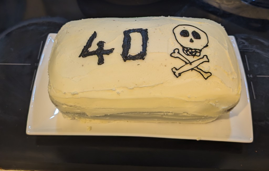 Cake made by Fleur, pictured with white icing and black 40 with skull and cross bones image.