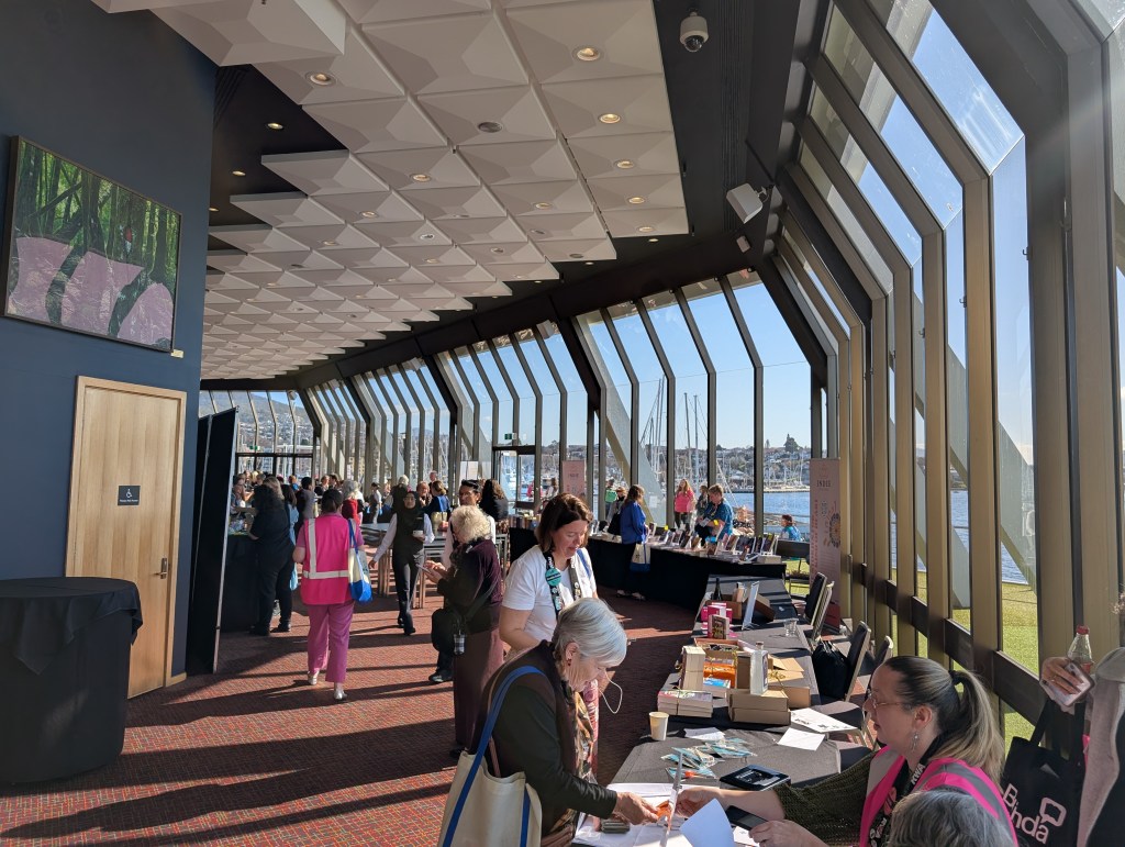 Sun-lit room with stalls along the right hand side